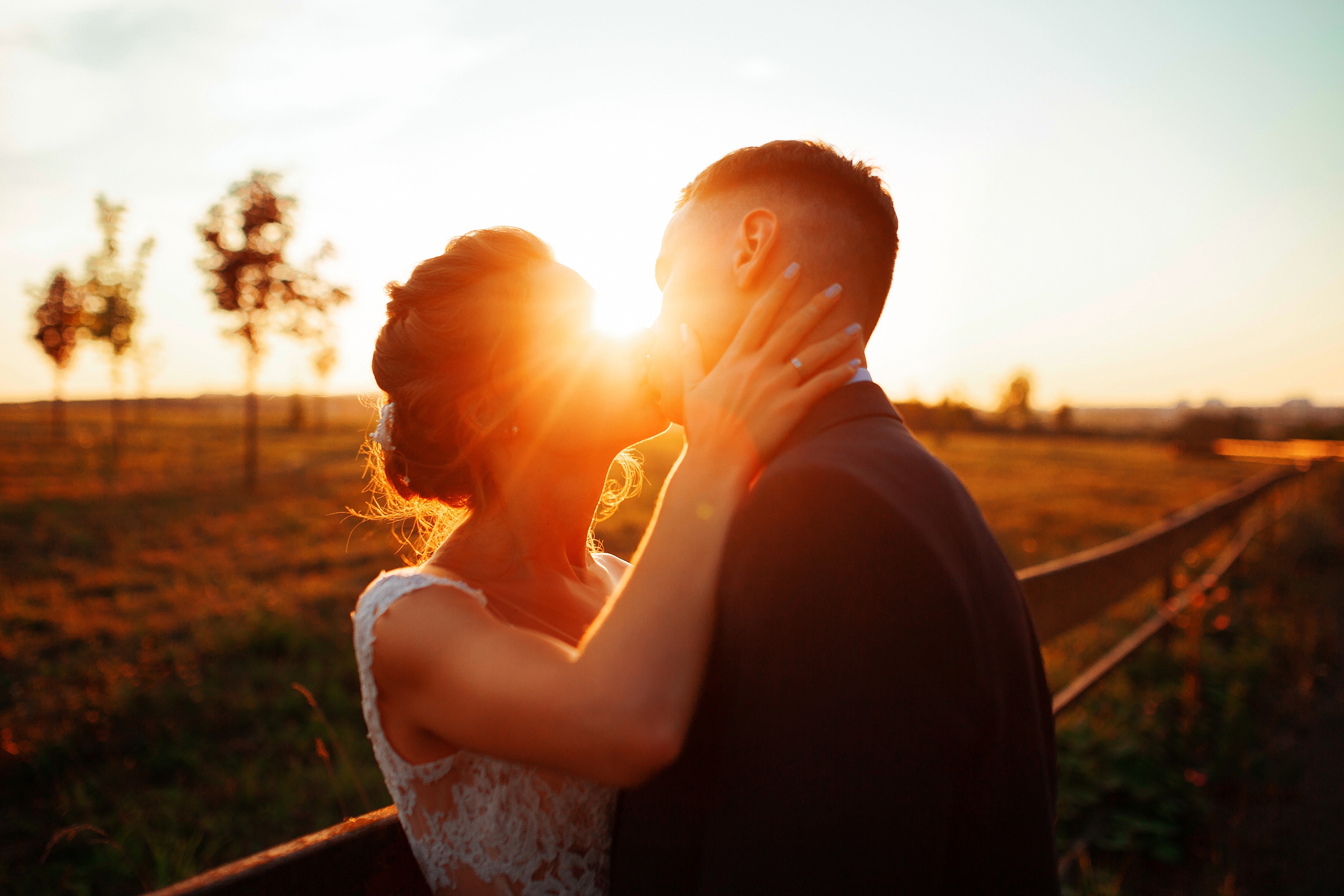A wedding kiss at the sunset