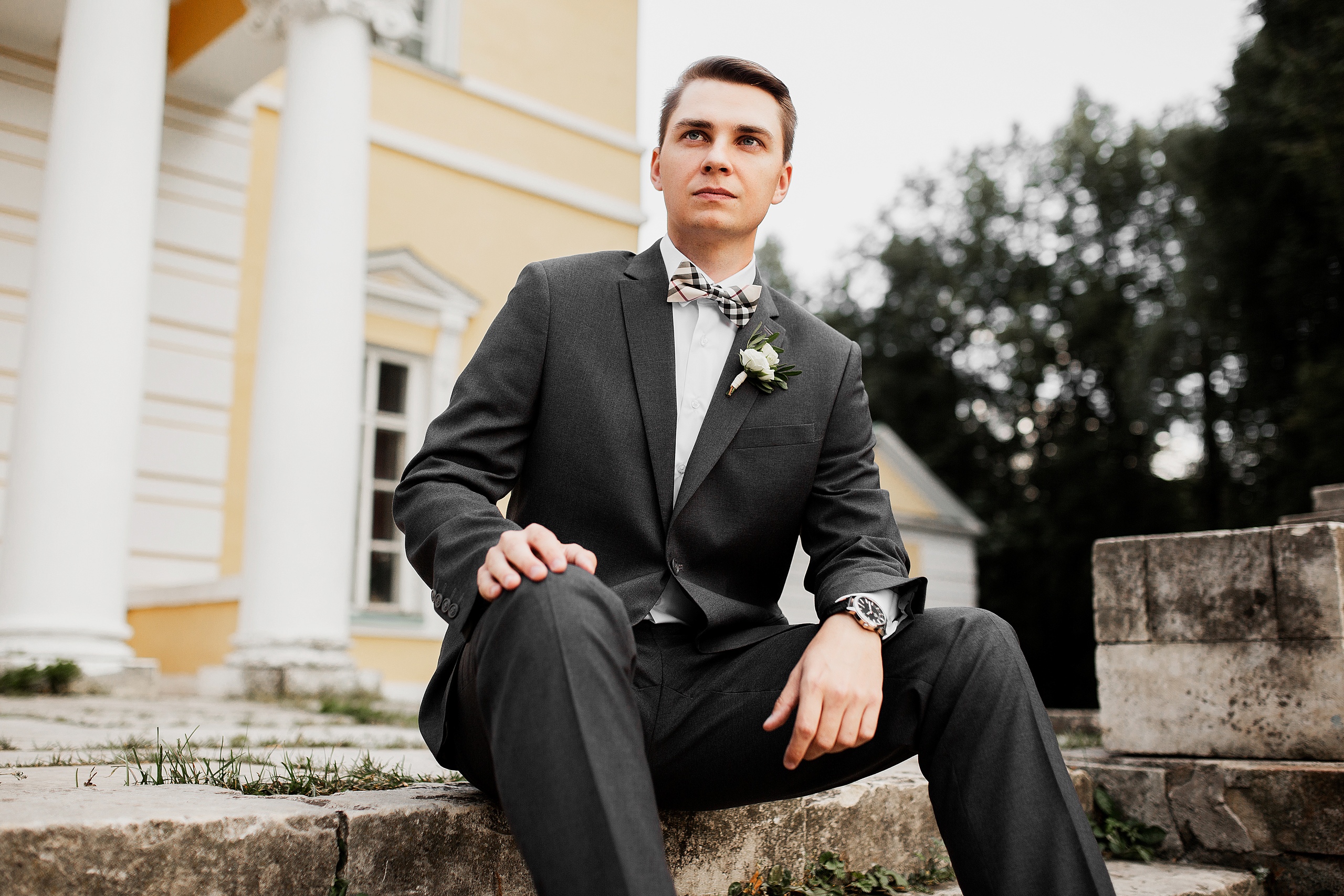 Wedding photoshoot groom sitting