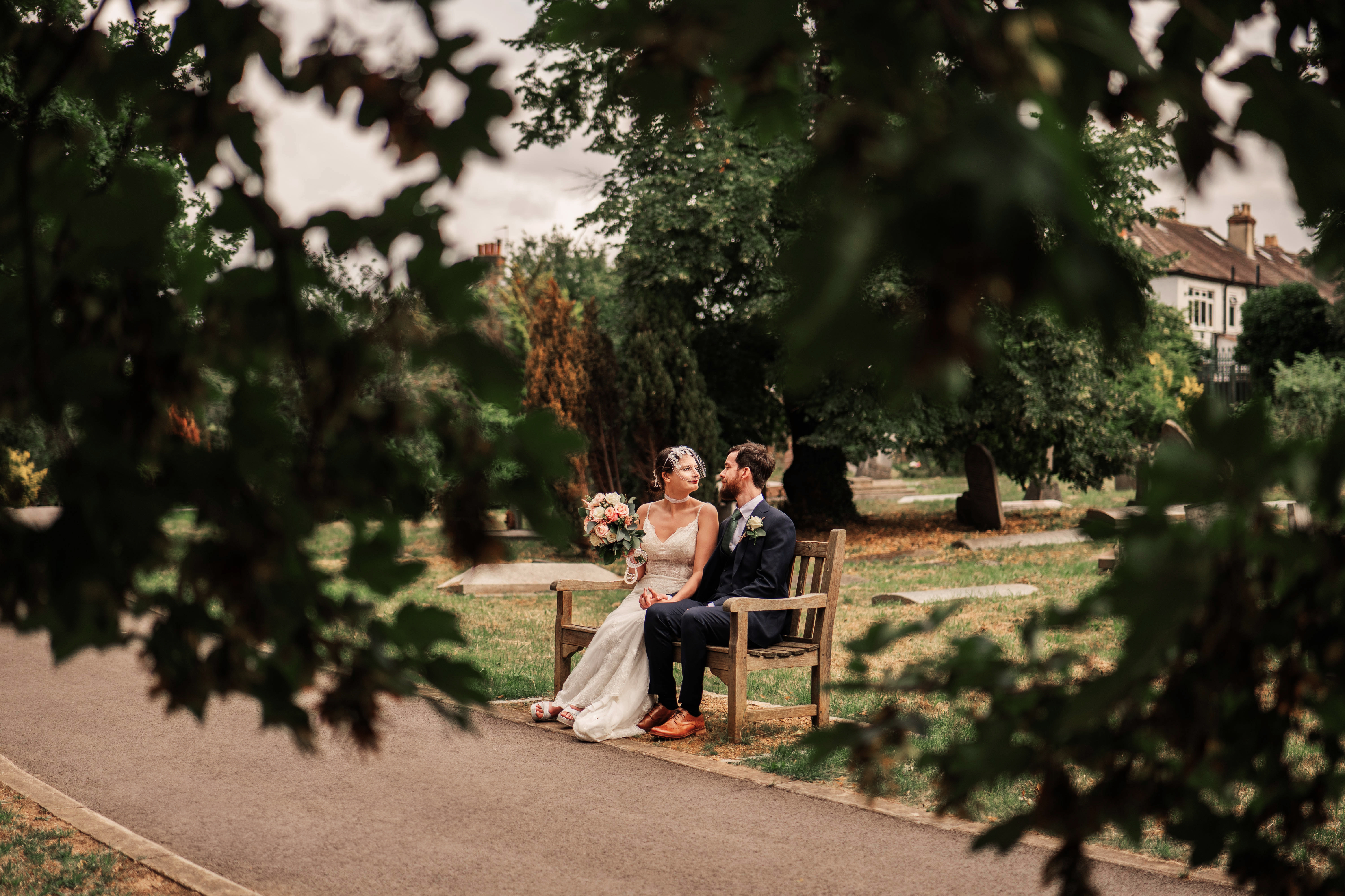 Wedding photo pair sitting in the park