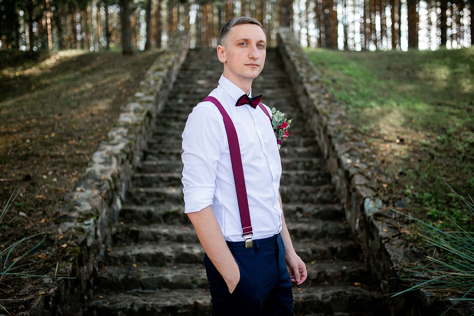 groom near the stairs in the forest
